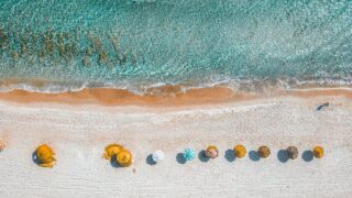 aerial view photography of umbrellas on shore