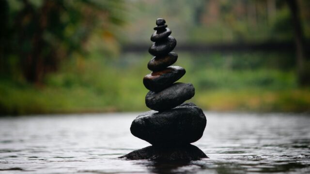 black stackable stone decor at the body of water