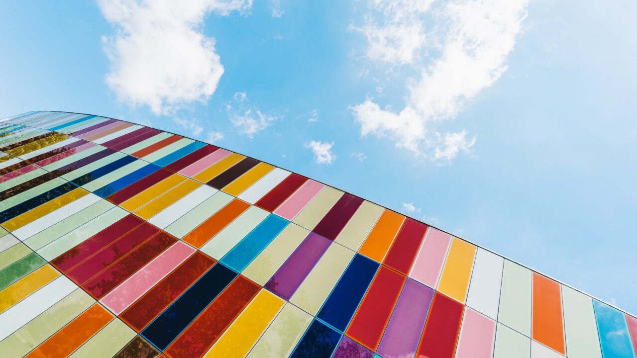 low angle of colorful glass panels under blue sky