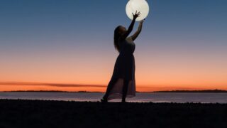 woman holding a moon